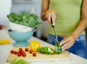 healthy woman chopping vegetables
