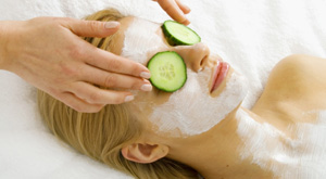 woman at spa with cucumbers on eyes