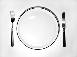 white plate with fork and knife