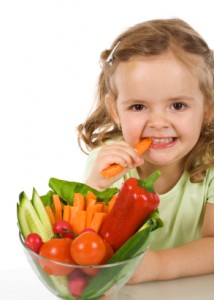 little girl eating a carrot