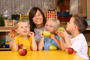 A teacher with three students eating fruit