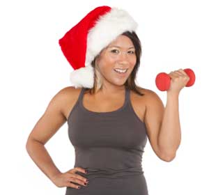 girl exercising while wearing a santa hat
