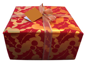holiday box wrapped in gold and red paper