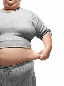 person pulling on stomach fat