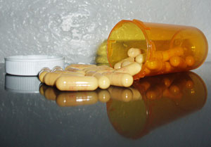 pills spilling out of a perscription bottle