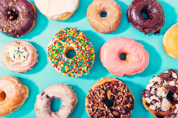 Assorted donuts on pastel blue background